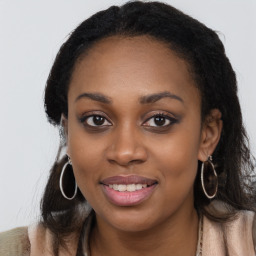 Joyful black young-adult female with long  brown hair and brown eyes