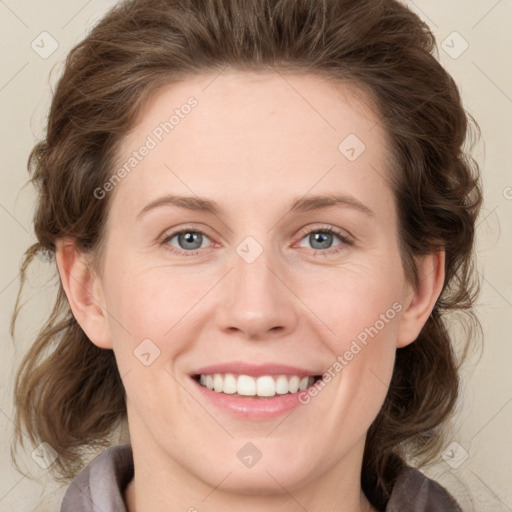 Joyful white young-adult female with medium  brown hair and blue eyes