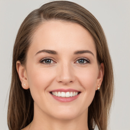 Joyful white young-adult female with long  brown hair and grey eyes