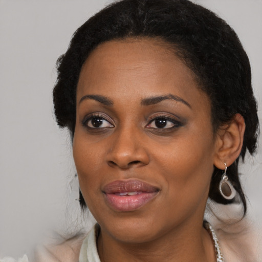 Joyful black young-adult female with medium  brown hair and brown eyes