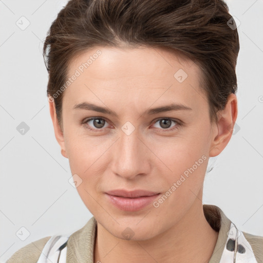 Joyful white young-adult female with short  brown hair and grey eyes