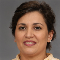 Joyful white adult female with medium  brown hair and brown eyes