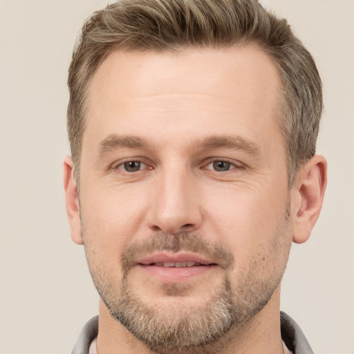 Joyful white adult male with short  brown hair and brown eyes