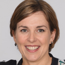 Joyful white adult female with medium  brown hair and grey eyes