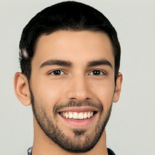 Joyful white young-adult male with short  black hair and brown eyes