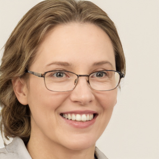 Joyful white adult female with medium  brown hair and blue eyes