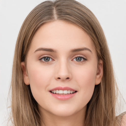 Joyful white young-adult female with long  brown hair and grey eyes