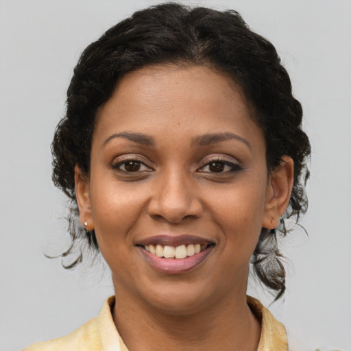 Joyful latino young-adult female with medium  brown hair and brown eyes