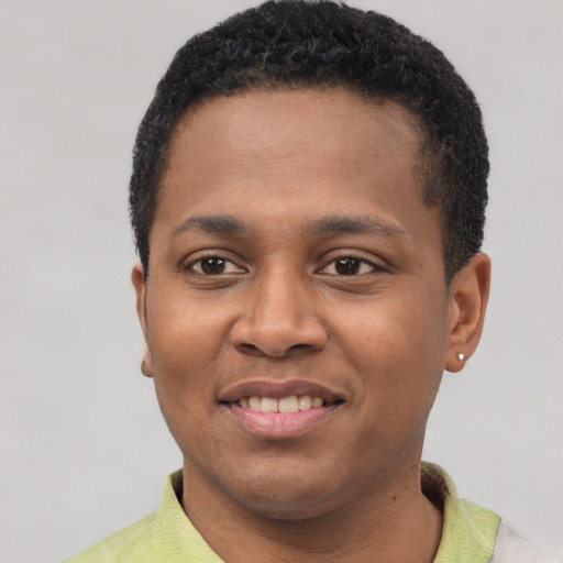 Joyful latino young-adult male with short  brown hair and brown eyes