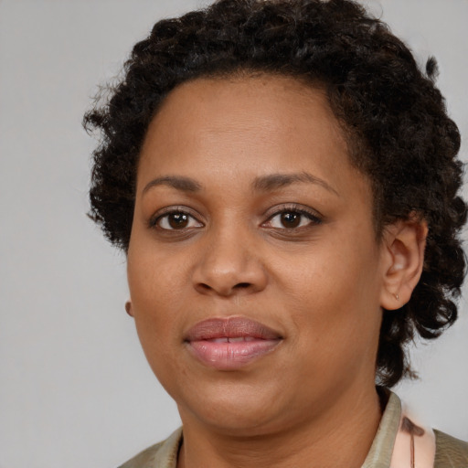 Joyful black adult female with short  brown hair and brown eyes