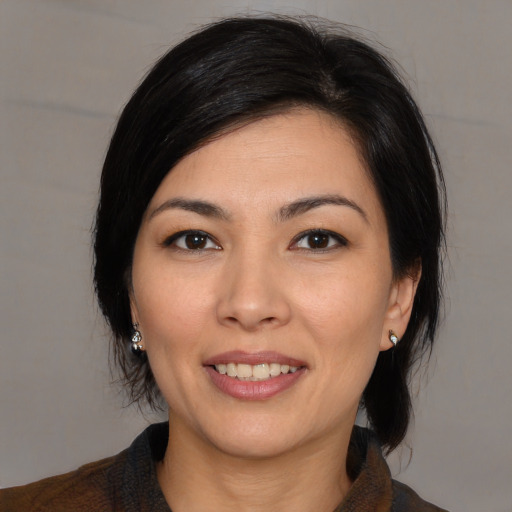 Joyful white young-adult female with medium  black hair and brown eyes