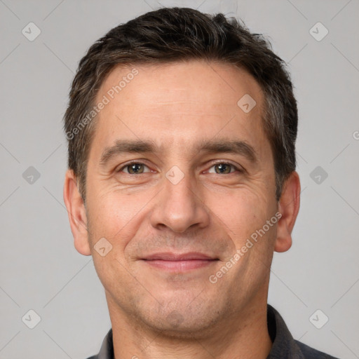 Joyful white adult male with short  brown hair and brown eyes