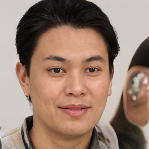 Joyful asian young-adult male with short  brown hair and brown eyes