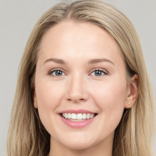 Joyful white young-adult female with long  brown hair and grey eyes