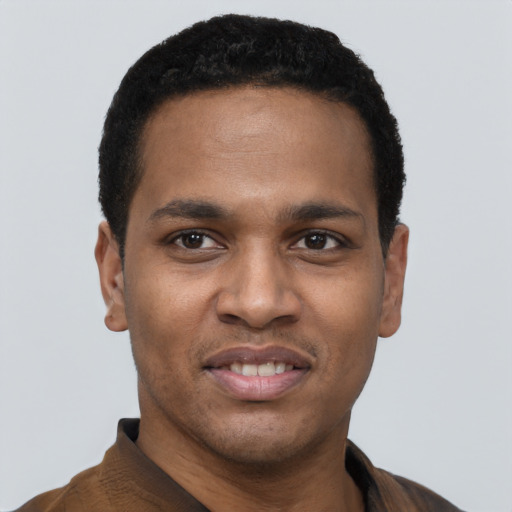 Joyful black young-adult male with short  black hair and brown eyes