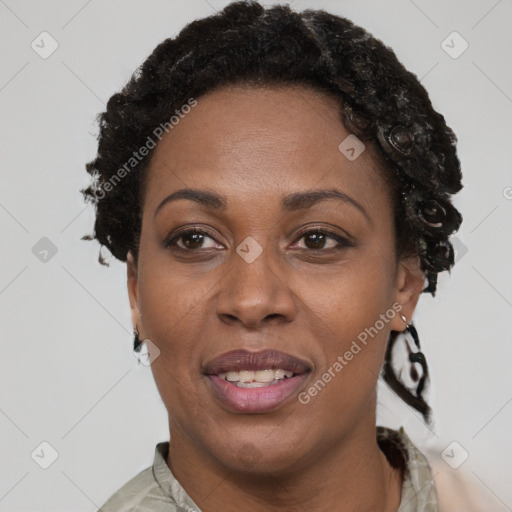 Joyful black adult female with short  brown hair and brown eyes