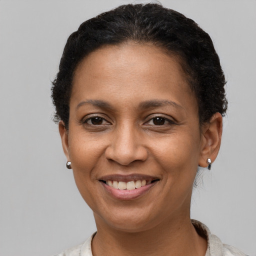 Joyful latino adult female with short  brown hair and brown eyes