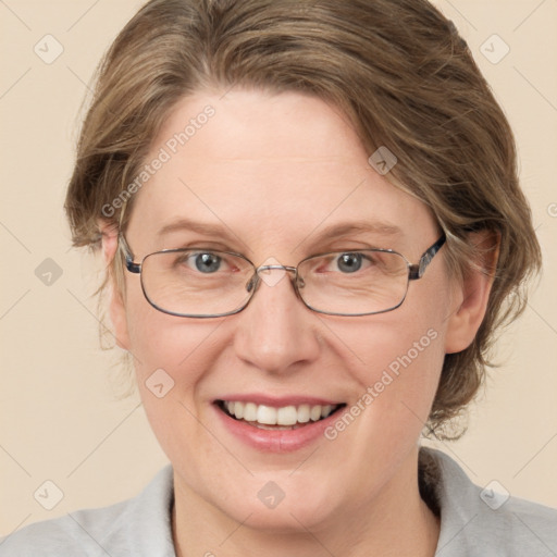 Joyful white adult female with medium  brown hair and blue eyes