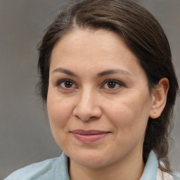 Joyful white adult female with medium  brown hair and brown eyes