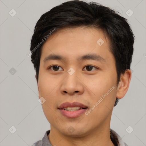 Joyful asian young-adult male with short  black hair and brown eyes