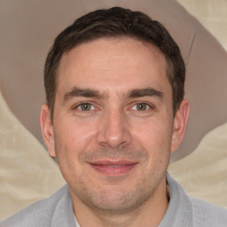 Joyful white adult male with short  brown hair and brown eyes