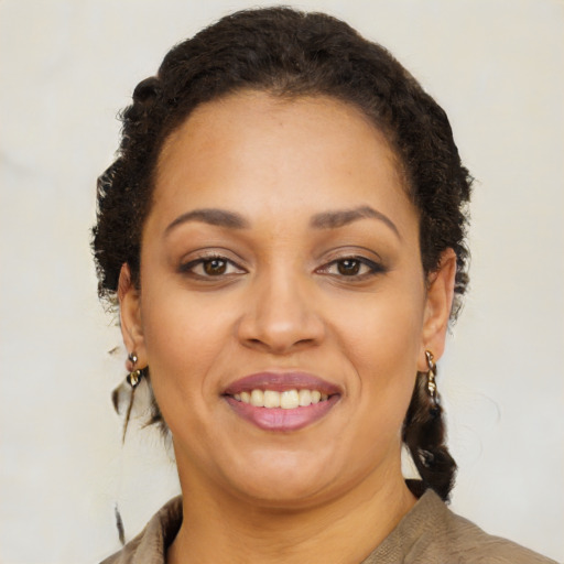 Joyful black young-adult female with medium  brown hair and brown eyes