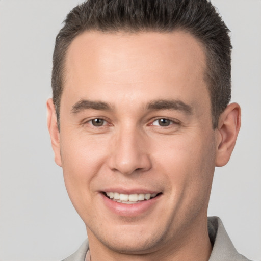 Joyful white young-adult male with short  brown hair and brown eyes