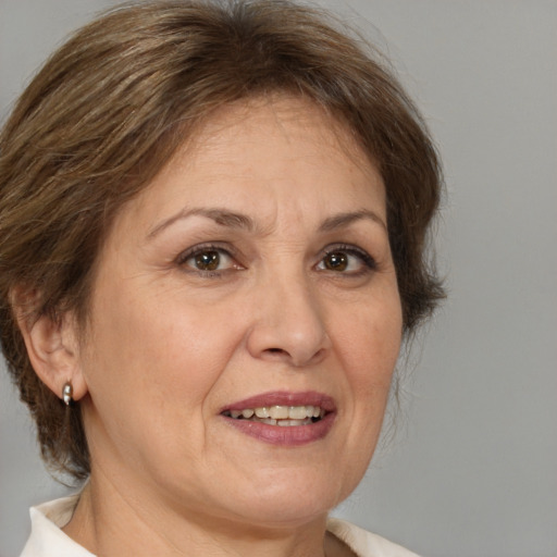 Joyful white adult female with medium  brown hair and brown eyes