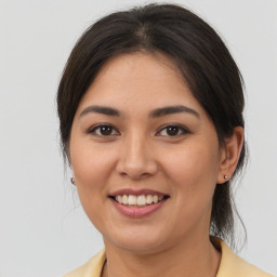 Joyful latino young-adult female with medium  brown hair and brown eyes