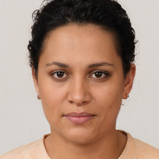 Joyful latino young-adult female with short  brown hair and brown eyes