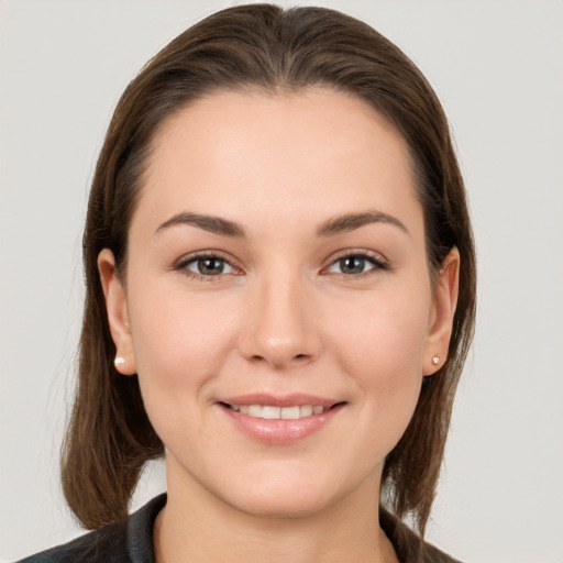 Joyful white young-adult female with long  brown hair and grey eyes