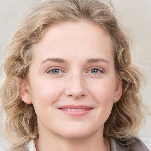 Joyful white young-adult female with medium  brown hair and blue eyes