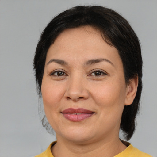 Joyful asian adult female with medium  brown hair and brown eyes