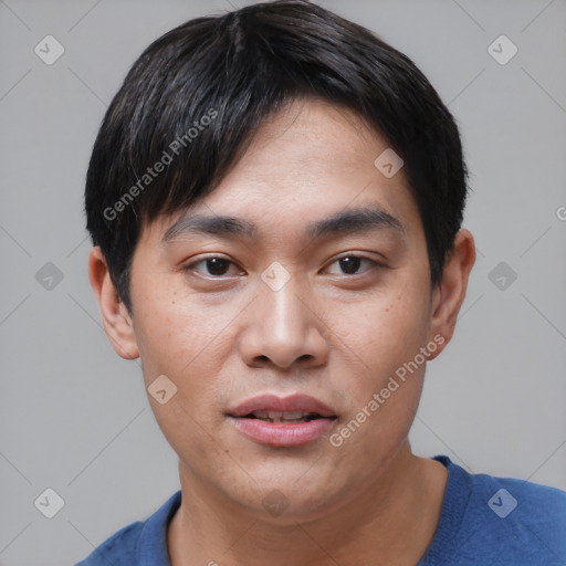 Joyful asian young-adult male with short  black hair and brown eyes
