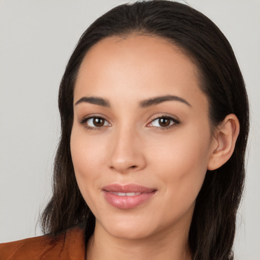 Joyful latino young-adult female with long  brown hair and brown eyes