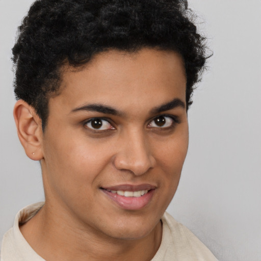 Joyful latino young-adult male with short  brown hair and brown eyes