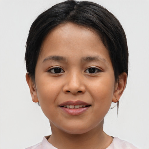 Joyful latino child female with medium  brown hair and brown eyes