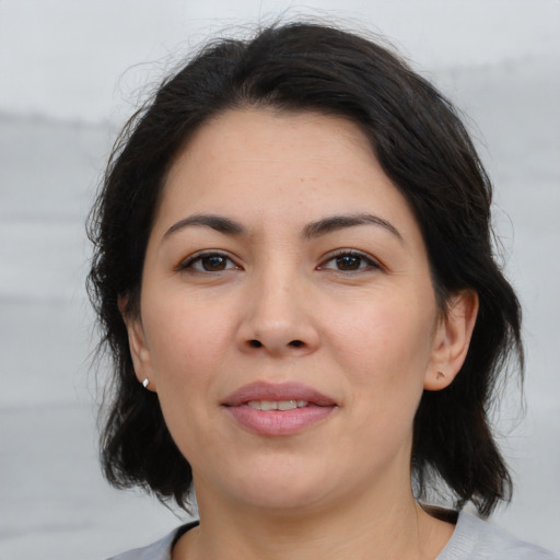 Joyful asian adult female with medium  brown hair and brown eyes