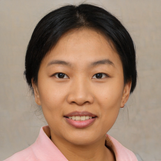 Joyful asian young-adult female with medium  black hair and brown eyes