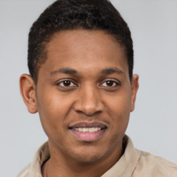 Joyful latino young-adult male with short  brown hair and brown eyes