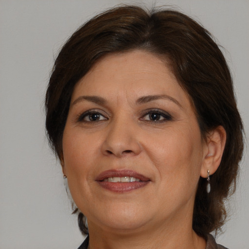 Joyful white adult female with medium  brown hair and brown eyes