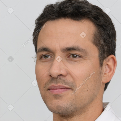 Joyful white adult male with short  brown hair and brown eyes