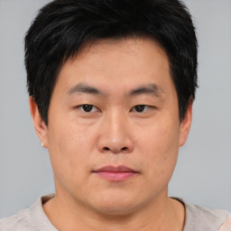 Neutral asian young-adult male with short  brown hair and brown eyes