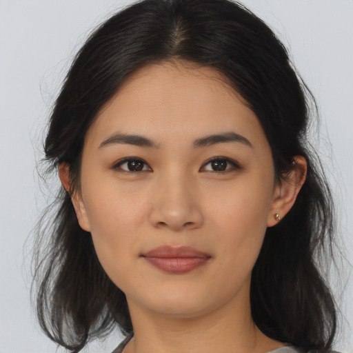 Joyful asian young-adult female with medium  brown hair and brown eyes