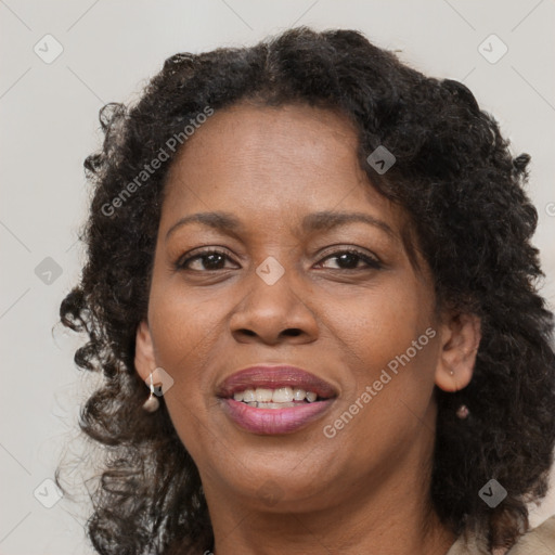 Joyful black adult female with medium  brown hair and brown eyes