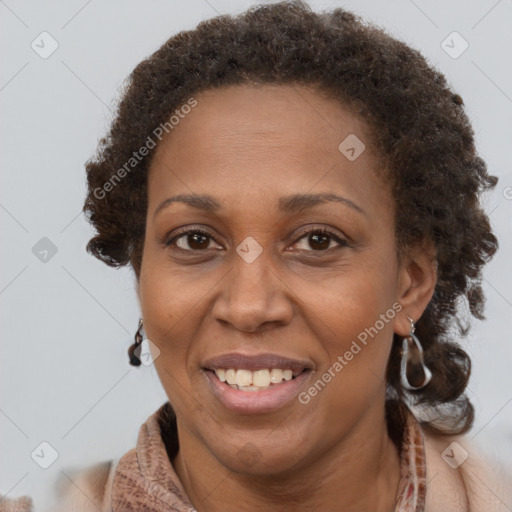 Joyful black adult female with short  brown hair and brown eyes