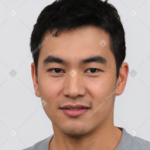 Joyful asian young-adult male with short  black hair and brown eyes