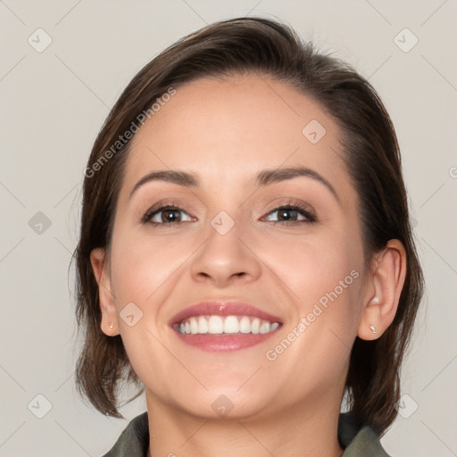 Joyful white young-adult female with medium  brown hair and grey eyes