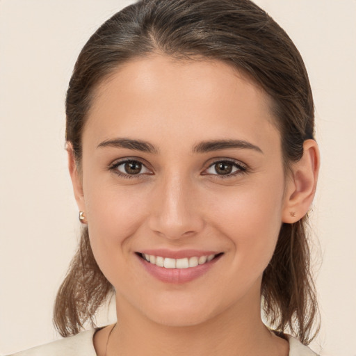 Joyful white young-adult female with medium  brown hair and brown eyes