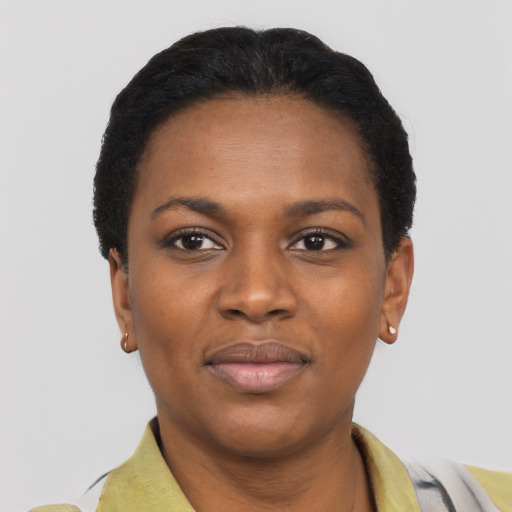 Joyful black young-adult female with short  black hair and brown eyes